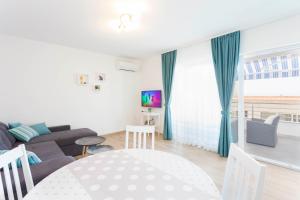 a living room with a couch and a table at Blue House in Makarska