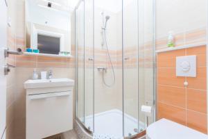 a bathroom with a shower and a toilet and a sink at Blue House in Makarska +21 photos