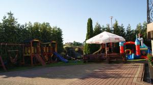 a park with a playground with an umbrella at Pokoje Gościnne-Kwatera u Evy in Swarzewo