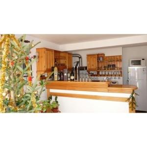 a kitchen with wooden cabinets and a christmas tree at Camere de inchiriat EDELWEISS in Dumbrava Roşie