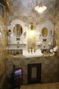 a bathroom with a sink and a mirror at Bloom Boutique Hotel in Tbilisi City