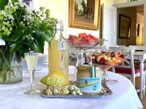 una mesa cubierta con tazones de frutas y copas de vino en Drottning Victorias Hotell & Vilohem, en Borgholm