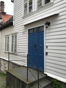 a blue door on the side of a house at The White House in Bergen