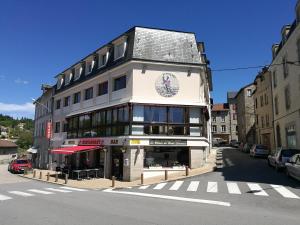 a building on the corner of a street at Le relais du Haut Limousin in Eymoutiers