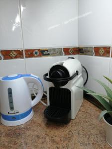 a toaster and a coffee maker sitting on a counter at Atico Sant Jordi in L'Ampolla