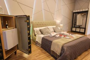 a bedroom with a bed with stuffed animals on it at REGGIA & DINTORNI ROOMS A CASERTA in Caserta