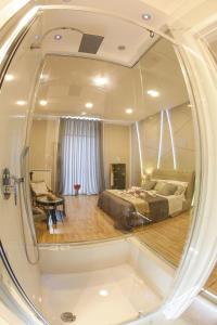 a room with a bed and a living room at REGGIA & DINTORNI ROOMS A CASERTA in Caserta
