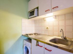 a kitchen with a sink and a washing machine at Apartment Les Caraïbes-3 by Interhome in Le Grau-du-Roi