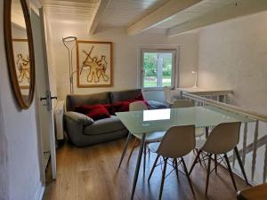 a living room with a couch and a table and chairs at Ferienwohnung Hamm Rhynern im alten Bauernhaus 1870 in Hamm