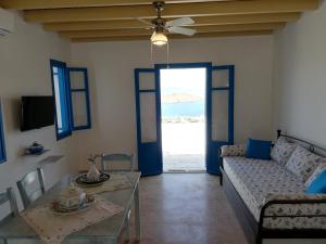 a living room with a couch and a table at Tirquaz View in Serifos Chora