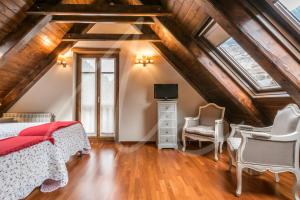 a attic bedroom with a bed and a tv at BACIVER in Aubert