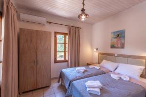 a bedroom with a bed with towels on it at Lucia's Home in Skala Potamias