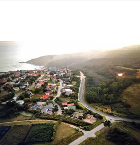 an aerial view of a town next to the ocean at Perlemoen Retreat in Herolds Bay