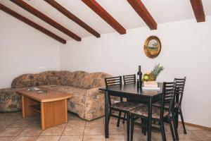 a living room with a table and a couch at Apartments Micic in Lovran