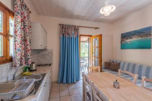 a kitchen and a living room with a table at Lucia's Home in Skala Potamias +22 photos