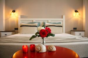 A bed or beds in a room at Bi Salkım Bozcaada Otel