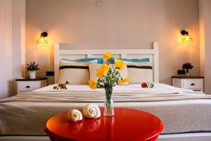 A bed or beds in a room at Bi Salkım Bozcaada Otel