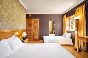 מיטה או מיטות בחדר ב-Hotel Castrum Villae by Walk Hotels