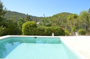 a swimming pool with a mountain in the background at Can Vich Petit in Sant Carles de Peralta