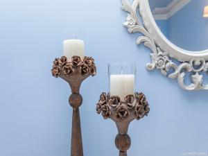 two candle holders on a wall with a mirror at Pateo Boaventura in Bairro Alto in Lisbon