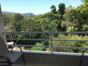 a balcony with a view of trees at Jaco Beach Penthouse in Jacó