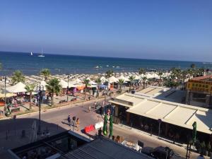 a town with a beach and the ocean at Larnaka Seaview Luxury Suites in Larnaka