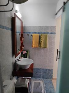 a bathroom with a sink and a mirror at Villa Romantza in Fiskardho +53 photos