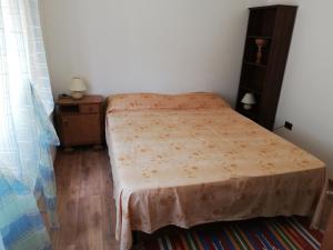 a small bedroom with a bed and a dresser at Villa Frane 101 in Beli