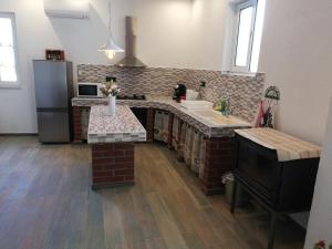 a kitchen with a brick counter and a sink at Villa Frane 101 in Beli