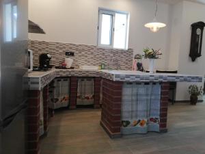 a kitchen with a brick island in the middle at Villa Frane 101 in Beli