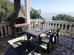 a table and chairs on a patio with a fireplace at Villa Frane 101 in Beli