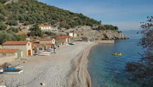 a group of boats on a beach next to the water at Villa Frane 101 in Beli