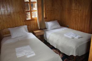 Posteľ alebo postele v izbe v ubytovaní Hosteria Rayen