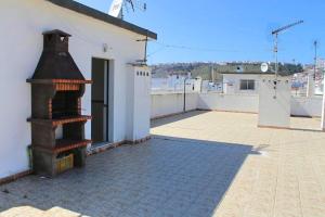 a building with a fireplace on top of a patio at Apartamento RH in Nazaré
