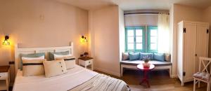 A bed or beds in a room at Bi Salkım Bozcaada Otel