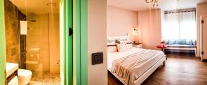 A bed or beds in a room at Bi Salkım Bozcaada Otel