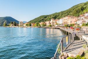 a view of a river with houses and buildings at Villa Rina Deluxe and Cottage in Porto Ceresio