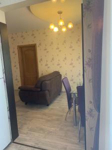 a living room with a couch and a chair at Александра Поля проспект Апартаменты in Dnipro +1 photo