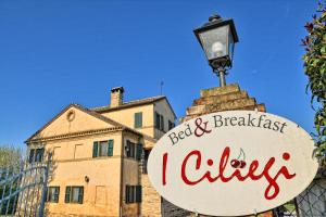 a sign in front of a building with a street light at I Ciliegi in Osimo