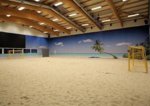 a volley ball court with a beach and a goal at BeachIN - Sport, Events, Hotel, Restaurant, Bar in Ins