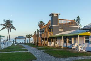 a large house with a balcony and a beach at Lost Inn Paradise in Cocoa Beach