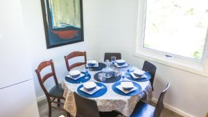 a dining room table with a blue and white table cloth at Krossmyrhill. Great house in Eik +23 photos