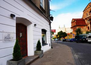 a building with a door on the side of a street at Apartamenty Centrum RS SUITES Kowalska 12 in Lublin