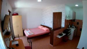 a small room with a small pink bed in it at Apartments Ceca in Tivat