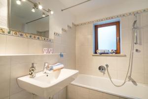 a bathroom with a sink and a bath tub at Ferienhof Alfred Albrecht in Oberstdorf +23 photos