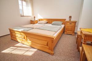 a bedroom with two wooden beds in a room at Pension Restaurant Bobrovník in Lipova Lazne