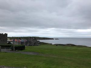 a view of a castle next to the ocean at Gilmore House in Ardglass