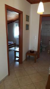 a room with a hallway with a toilet and a table at HOUSE DILENA TSIMTSIRI in Limenaria +49 photos