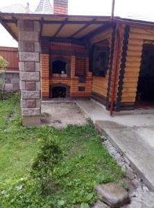 an outside view of a house with a patio at Zatushok pid goroyu in Verkhovyna