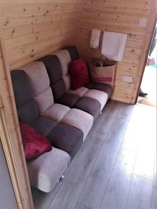 a living room with a couch and a chair at shanagarry / Ballycotton Glamping pod in Cork